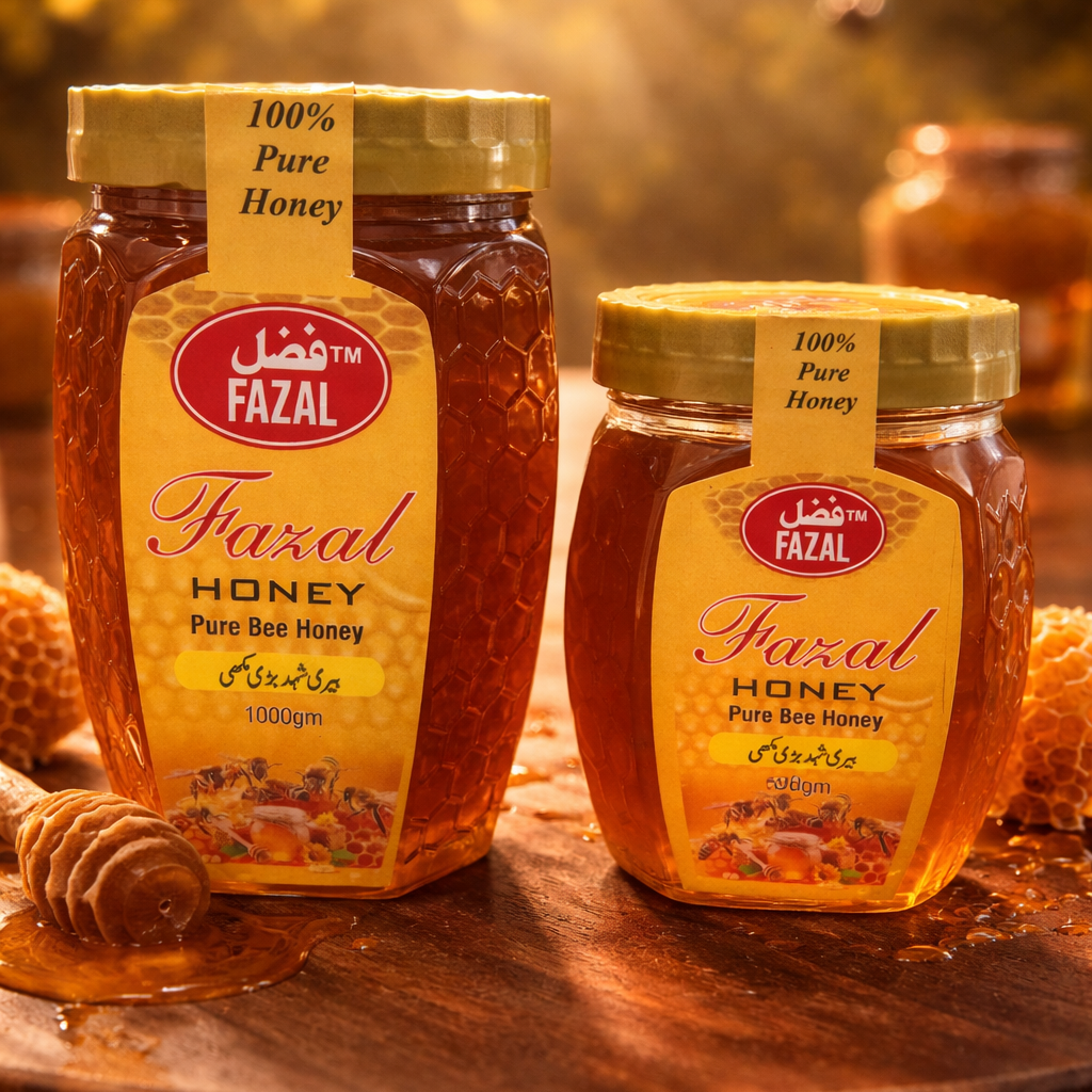 Two jars of Fazal honey on a wooden surface with honeycomb and dipper in the background.